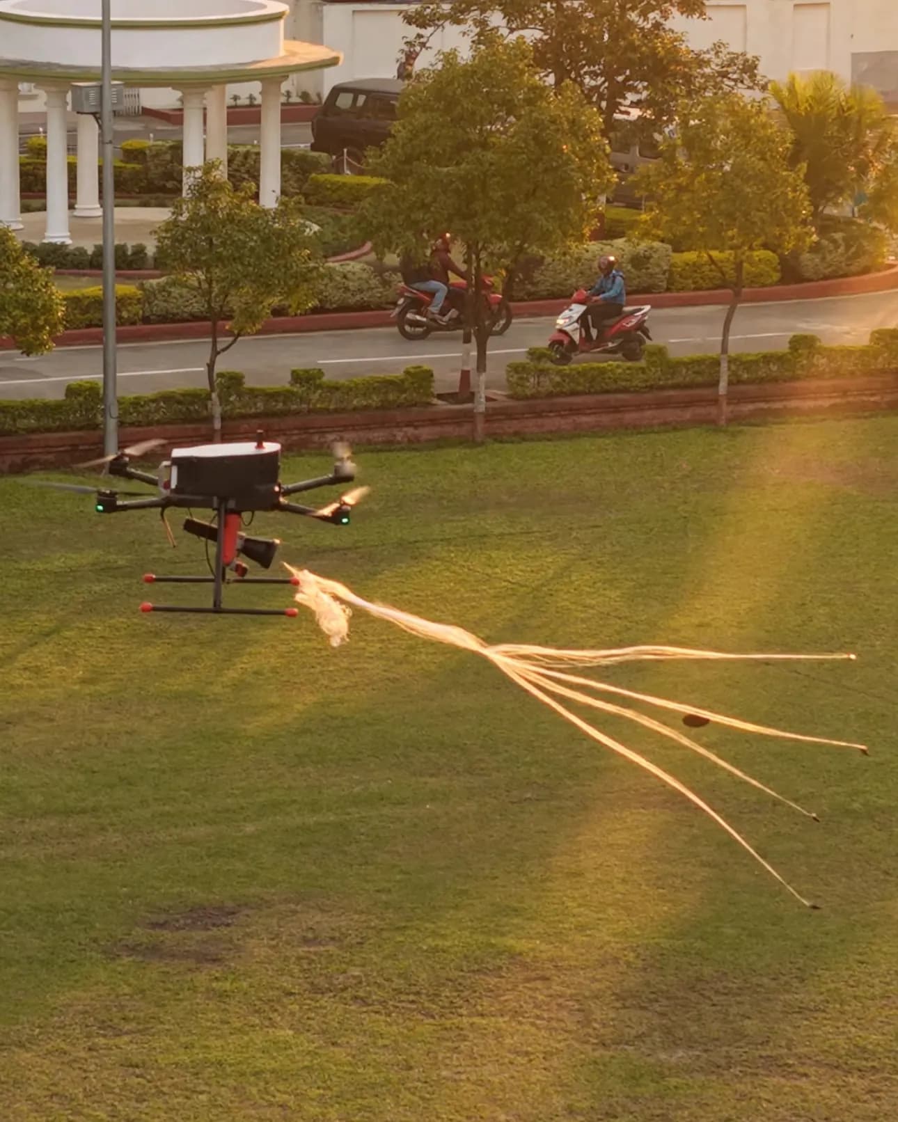 SkyReaper pulling lines across a field at golden hour