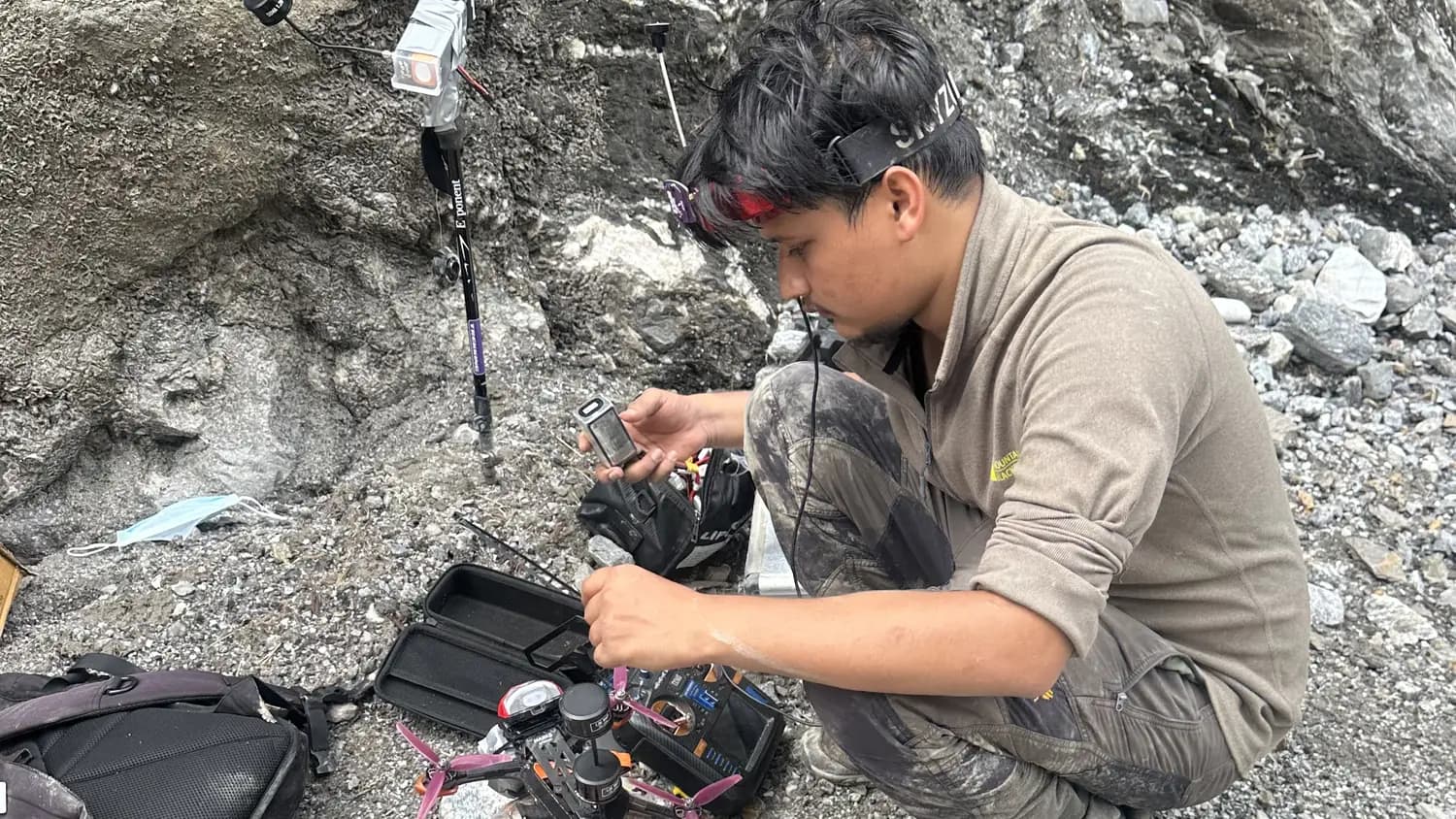 Adarsha outside the Upper Trishuli-1 tunnel, setting up the video relay and an FPV drone, August 2026