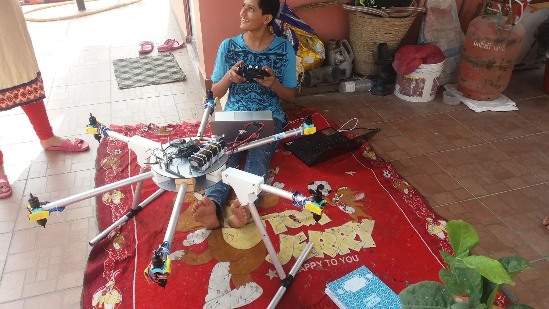 Adarsha at home with his homemade 12-rotor drone: six arms, twelve motors, 2018